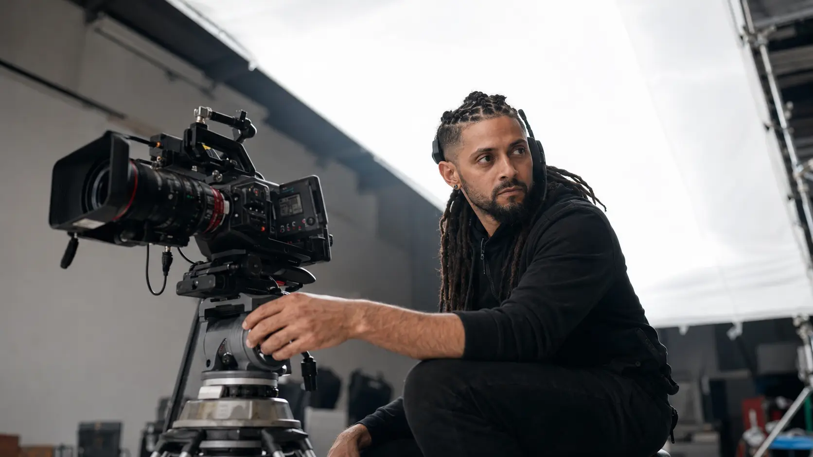 Fabien beside a cinema camera during a studio production
