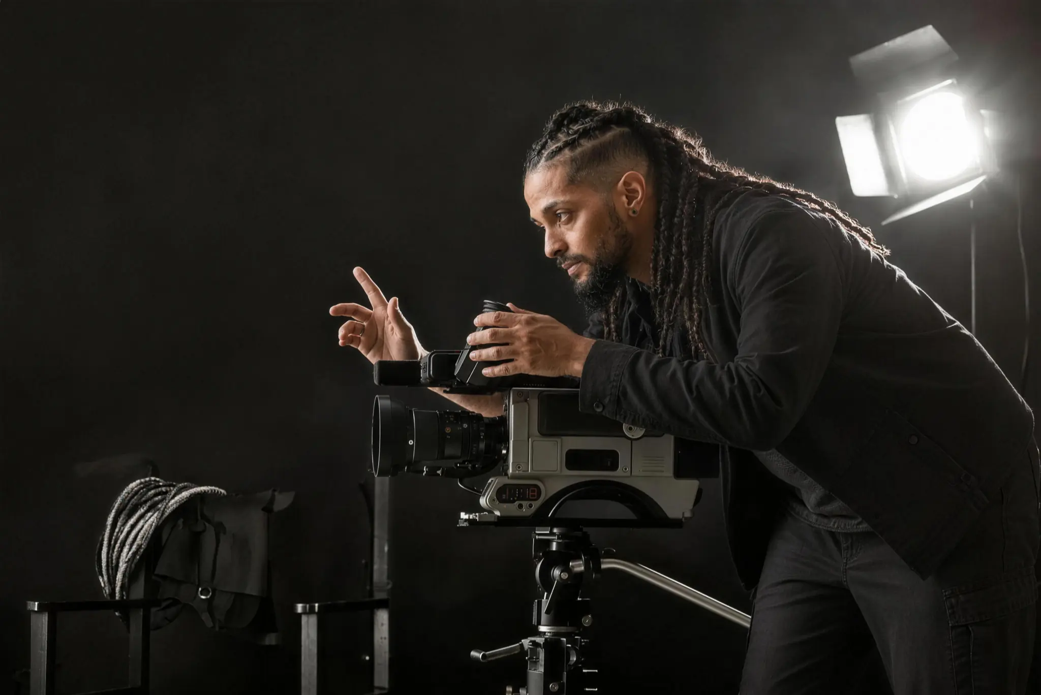 Fabien Bolle-Soazandry directing beside a cinema camera on a dark studio set